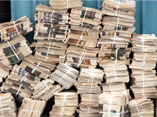 Huge pile of old newspapers stacked up. 