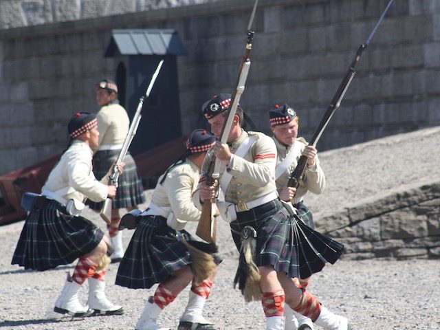 men in kilts doing military manouevres