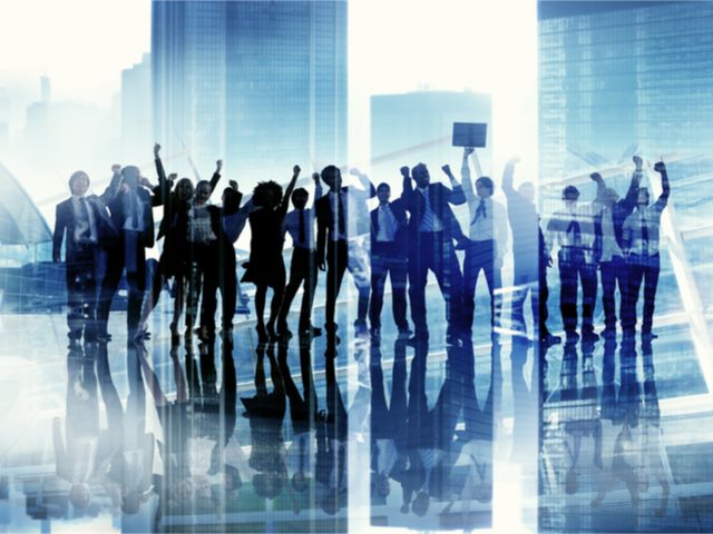 A group of silhouetted business people celebrated