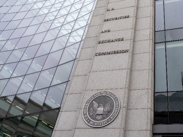 SEC sign and logo on the modern glass building in Washington DC; the U.S. Securities and Exchange Commission is an independent agency of the United States federal government in piece about the SEC's new data breach rule. 