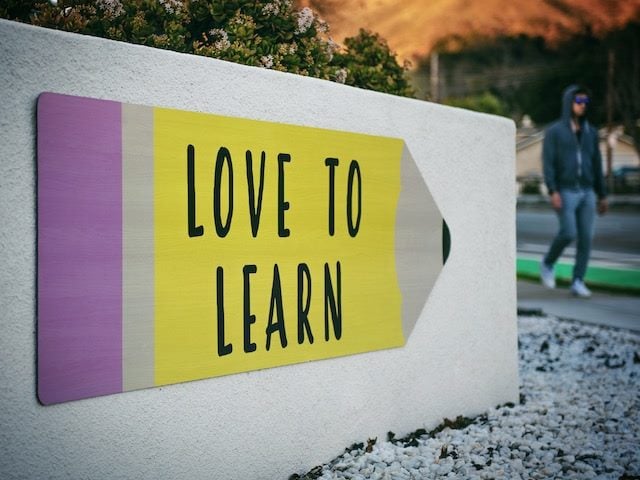 sign in the shape of a number 2 pencil which states "Love to Learn"