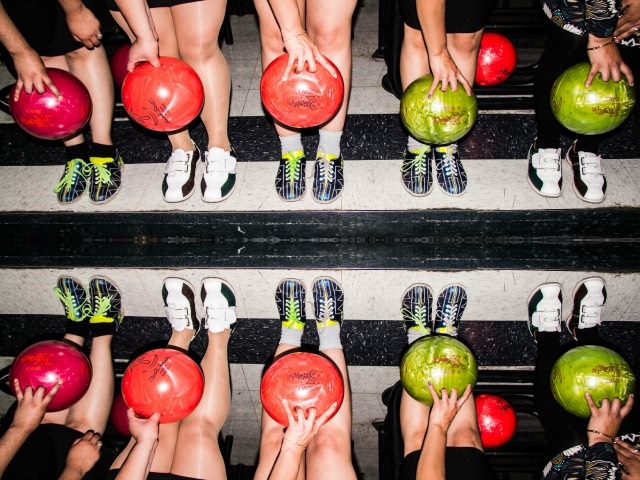 10 women with bowling balls