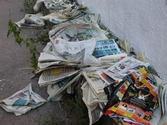 newspapers crumbled up on the ground.