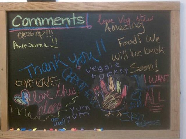 a chalkboard filled with customer feedback for a restaurant