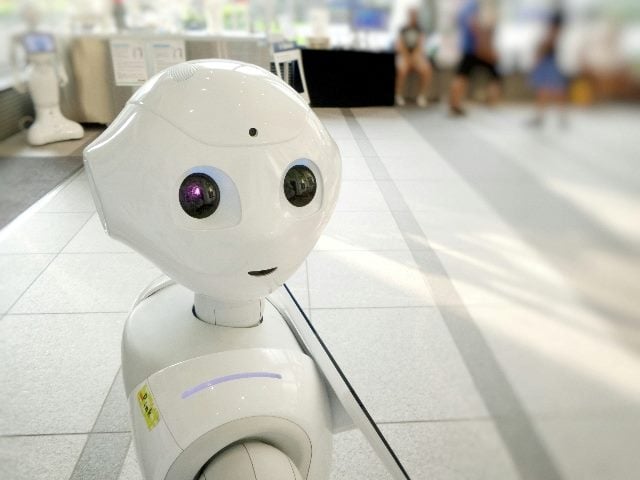 White robot looking at camera.