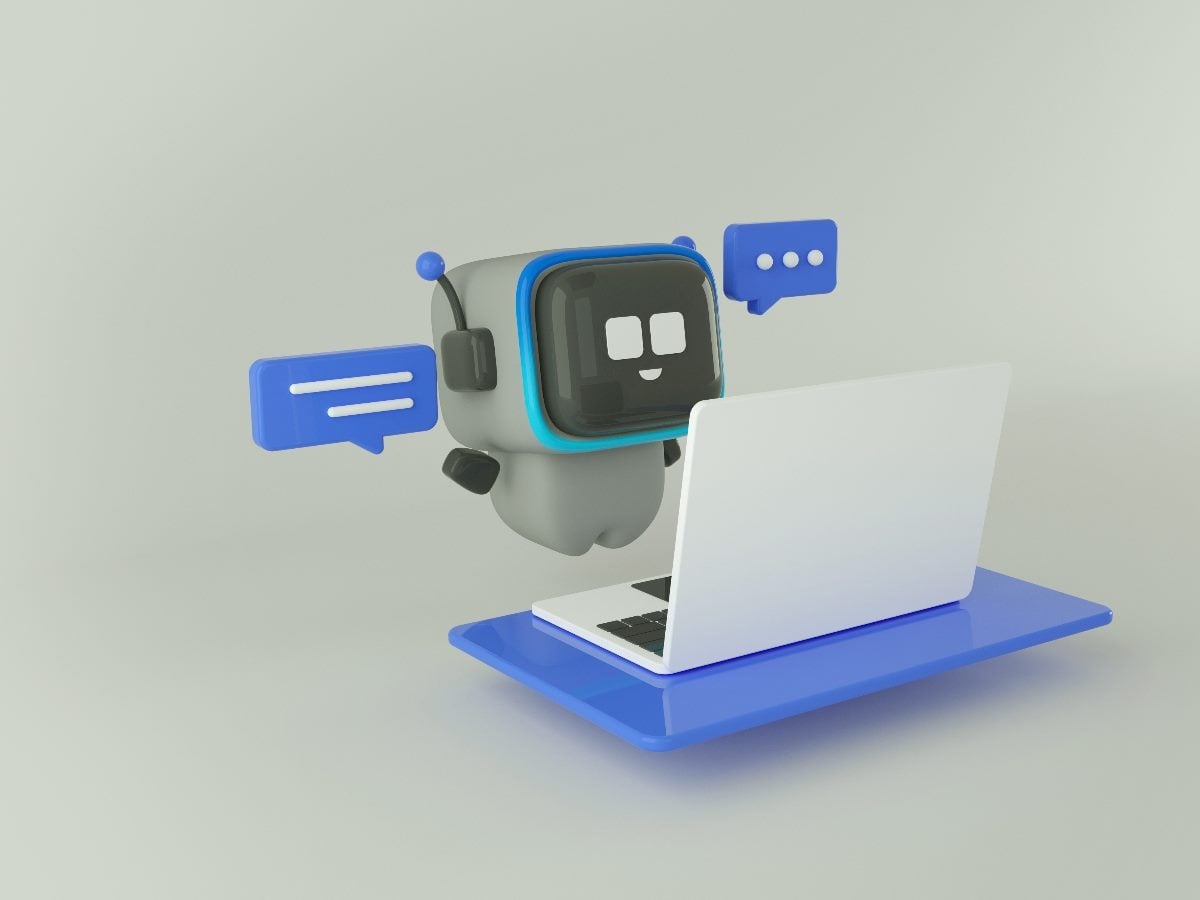 3D illustration of a friendly AI chatbot robot wearing a headset, interacting with chat message bubbles while working at a laptop, representing automated customer support and conversational AI.