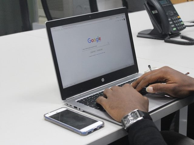 man starting a Google search on a laptop