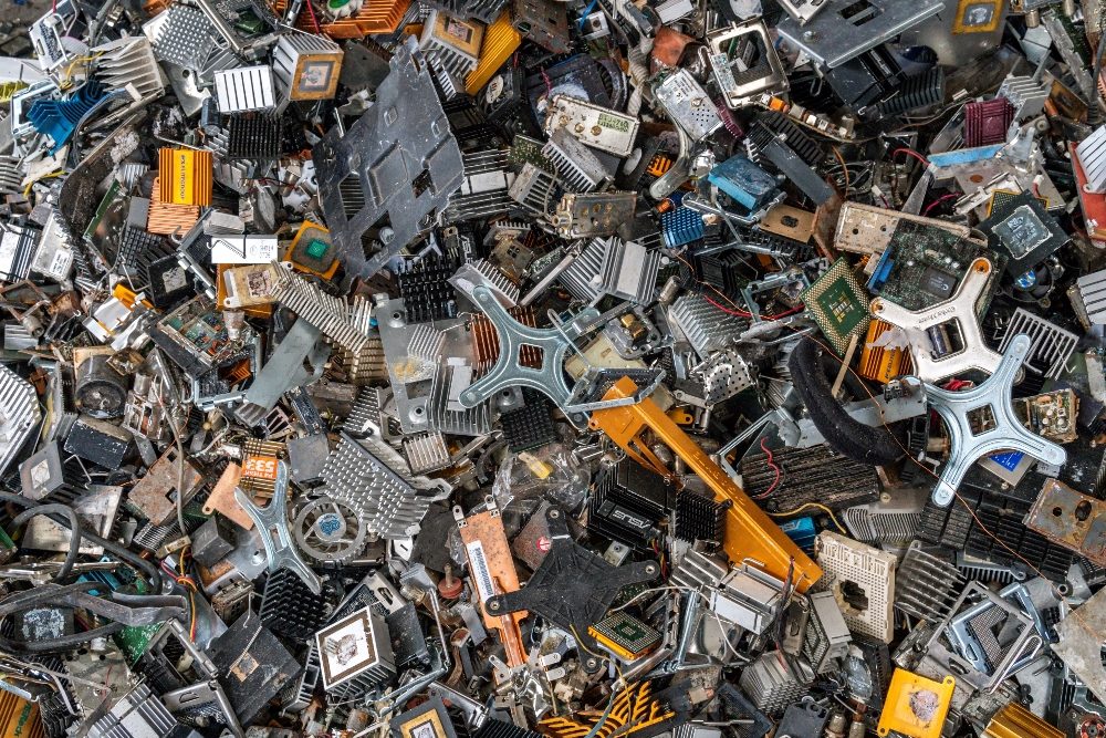 Scrap yard electronic waste for recycling with selective focus on electronic aluminium waste im piece about lack of digital sustainability and overconsumption.
