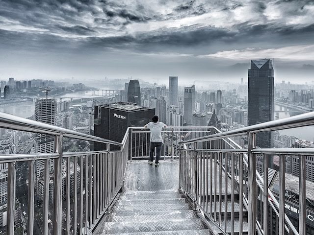 person looking out at a city