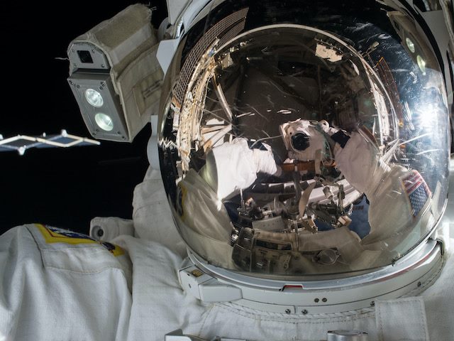 close up of  an astronaut making repairs in  space